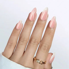 Stylish pink almond-shaped nails with white tips and wavy designs, complemented by a gold ring.