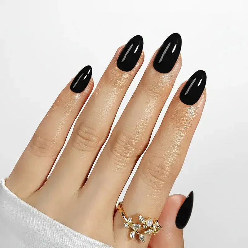 Stylish long black acrylic nail set, glossy finish, perfect for a bold look.