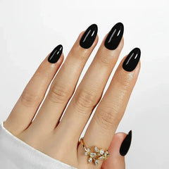 Stylish long black acrylic nail set, glossy finish, perfect for a bold look.