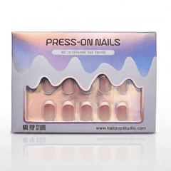 Box of press-on nails with a gradient design and visible brand name.