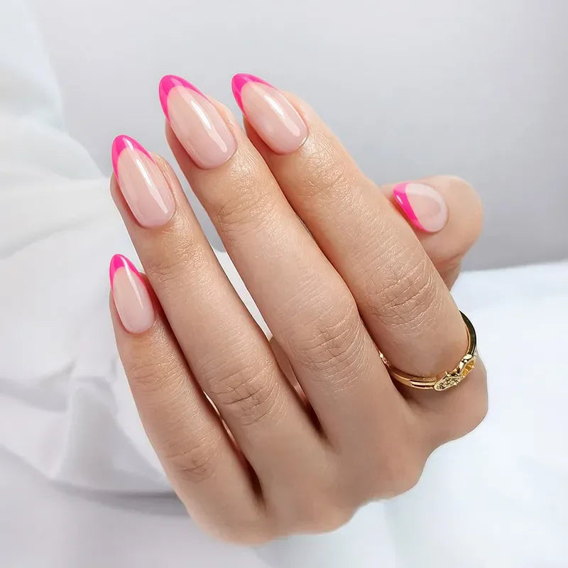 Elegant almond-shaped nails with pink tips and nude base, showcasing trendy nail art.