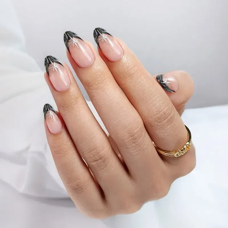 Elegant black French tip nails with star accents, showcasing a natural nail finish.