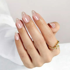 Elegant pink almond-shaped nails with a glossy finish, complemented by a gold ring.