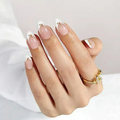 Elegant French tip nails in pink and white with gold accents, showcasing a stylish and sophisticated look.
