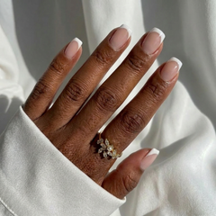 Hand wearing a ring with a white background