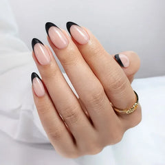 Elegant nude manicured nails with black tips, showcasing a stylish design and perfect for any occasion.